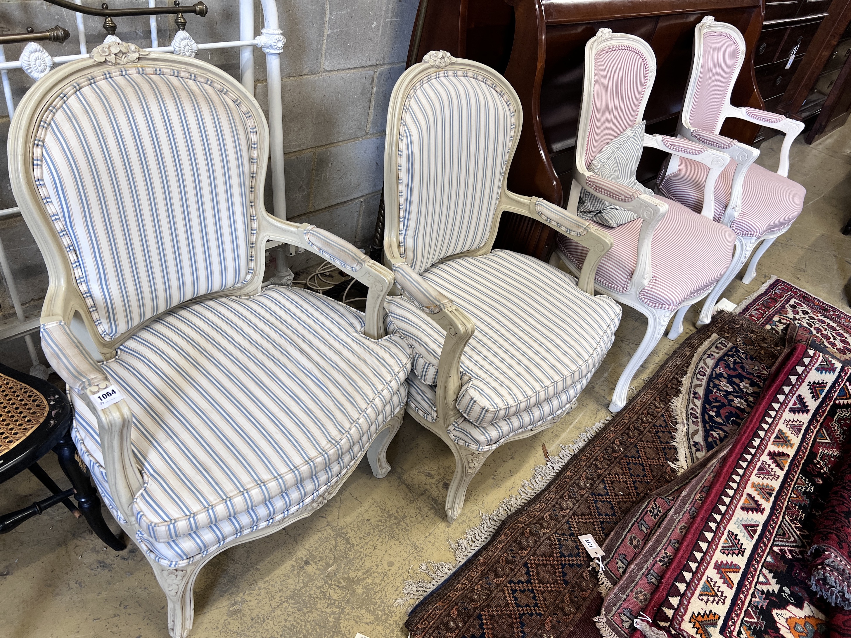 Two pairs of cream painted Louis XVI style fauteuil, heights 95cm and 91cm